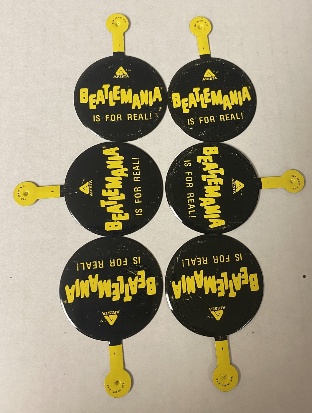Mint 1978 Arista Beatles pin with iconic logo and "Beatlemania Is For Real!"—a rare collectible. Mint 1978 Arista Beatles pin with iconic logo and "Beatlemania Is For Real!"—a rare collectible.